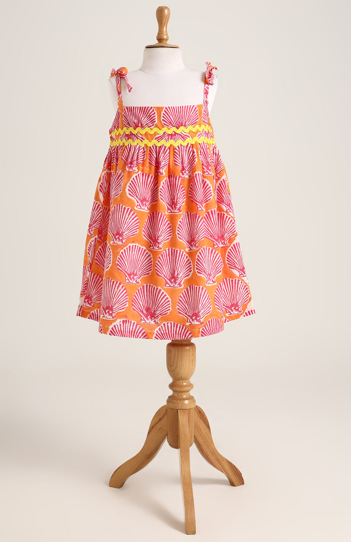 Printed cotton dress. Detailed with colourful strings on shoulder and  tied bow straps.