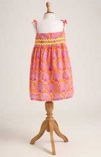 Printed cotton dress. Detailed with colourful strings on shoulder and  tied bow straps.