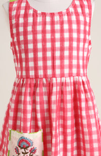 Cotton printed sleevesless checks Dress. Detailed with front Pocket and Back Criss Cross Wrap