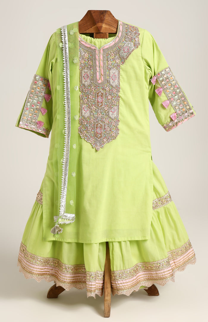 Mulmul Plain Kurta and Sharara paired with Soft Net dupatta. Detailed with big Neck Patch and Gota Patti/Lace