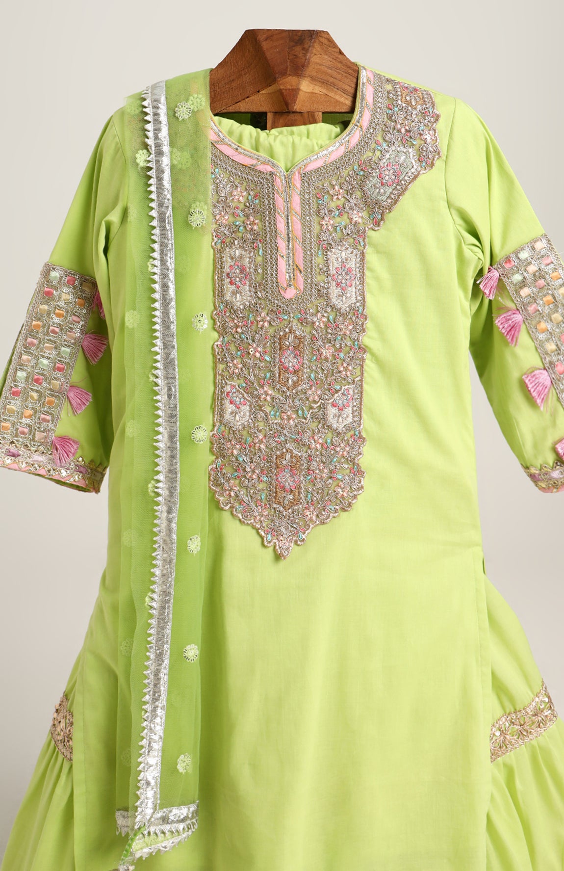 Mulmul Plain Kurta and Sharara paired with Soft Net dupatta. Detailed with big Neck Patch and Gota Patti/Lace