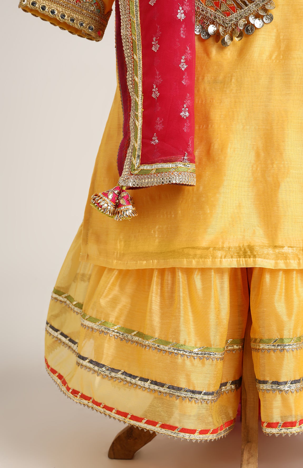 Chanderi Plain Kurta and Sharara paired with Soft Net dupatta. Detailed with big Neck Patch and Gota Patti/Lace
