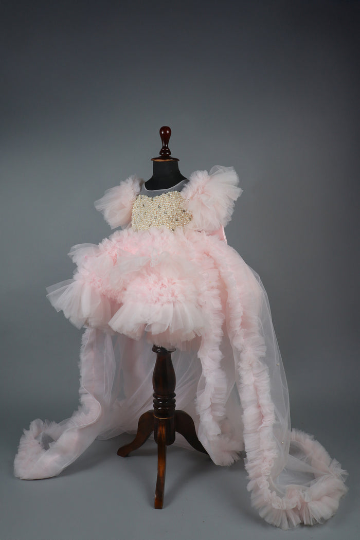 Embellised layered pink dress with detachable trail and bow with swirled bowie hairband