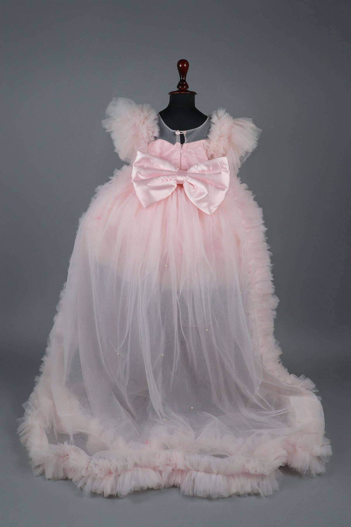 Embellised layered pink dress with detachable trail and bow with swirled bowie hairband