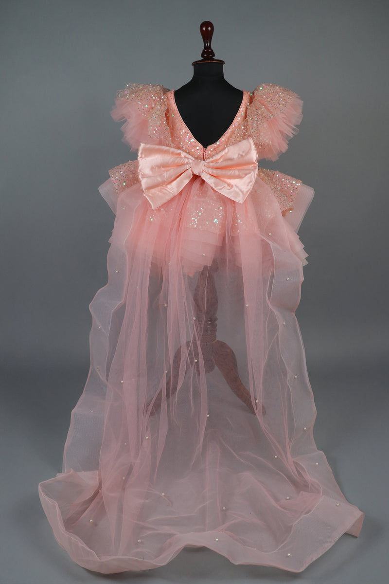 peach sequence embellised dress featurling a detachable trail and bow with swired bow headband