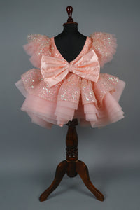 peach sequence embellised dress featurling a detachable trail and bow with swired bow headband