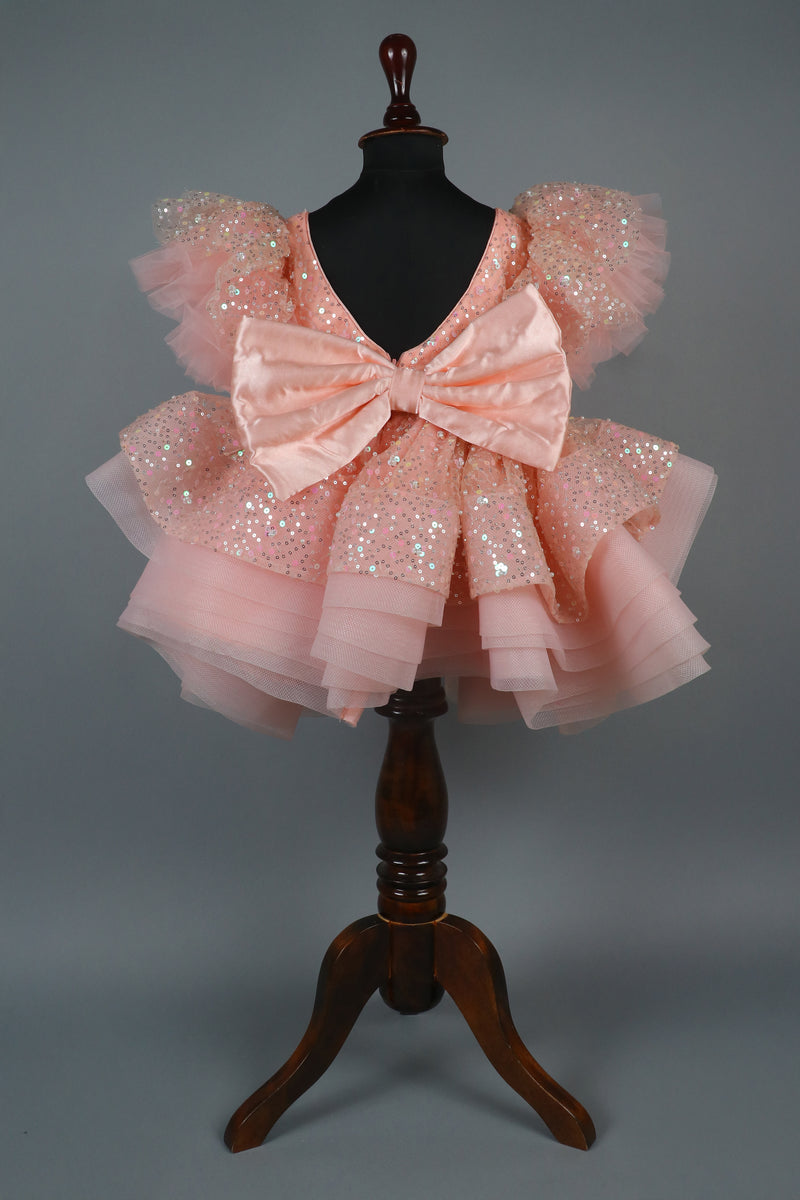 peach sequence embellised dress featurling a detachable trail and bow with swired bow headband
