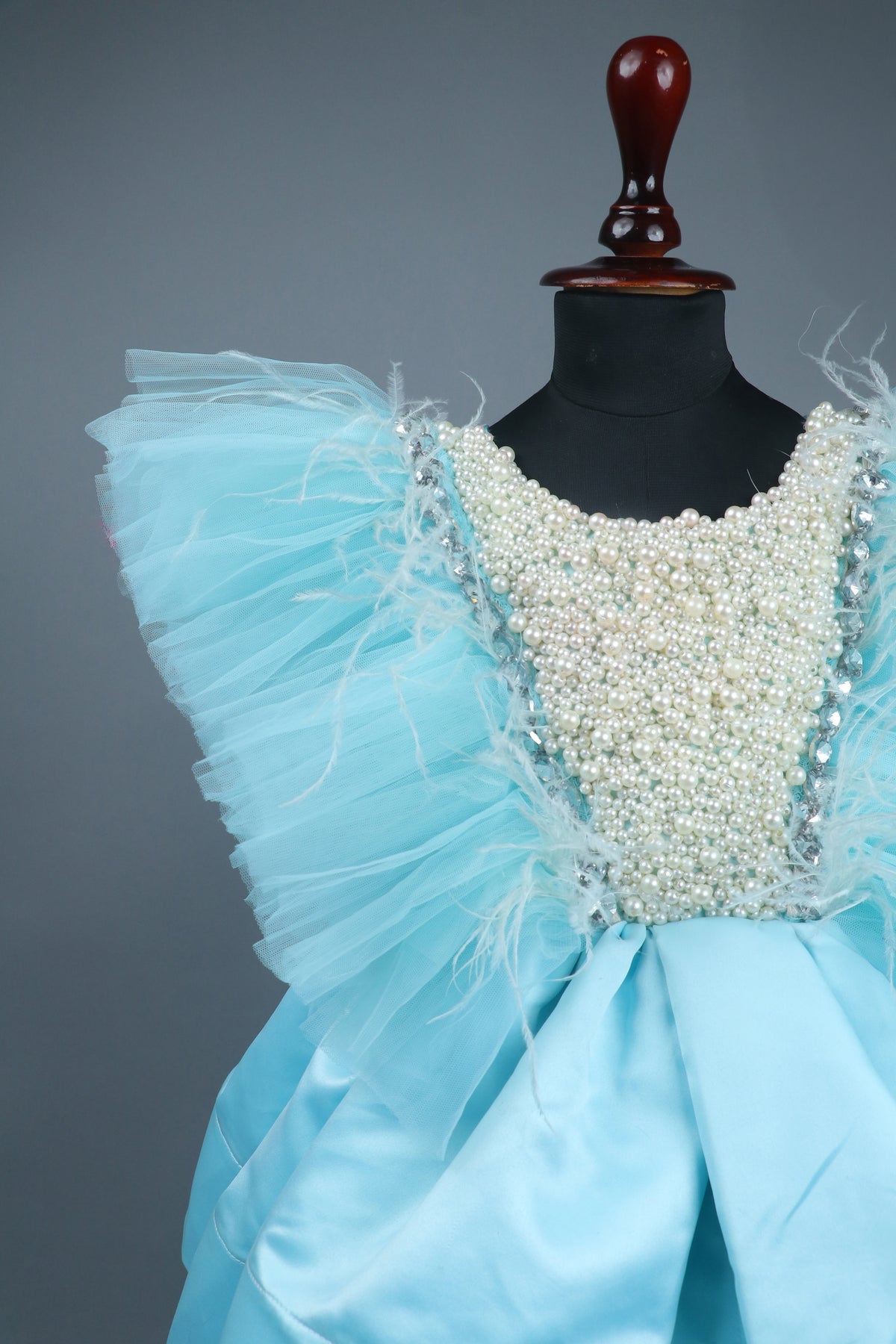 sky blue dress with purles work in chloi and feathers with head band and detachable bow