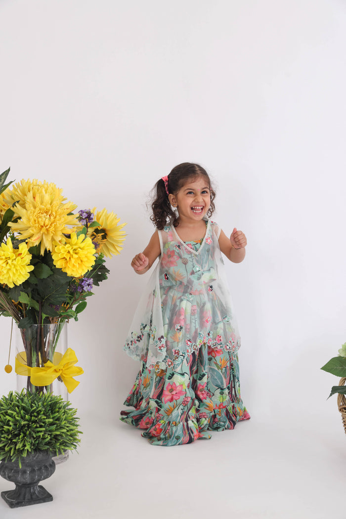 Blue Organza Cape With Cutwork Flowers And Pearls With Printed Muslin Lehenga And Top