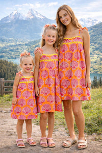 Printed cotton dress. Detailed with colourful strings on shoulder and  tied bow straps.